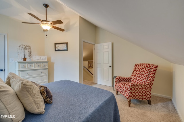 carpeted bedroom with vaulted ceiling and ceiling fan