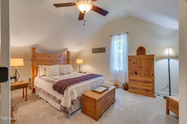 bedroom featuring light carpet, vaulted ceiling, and ceiling fan