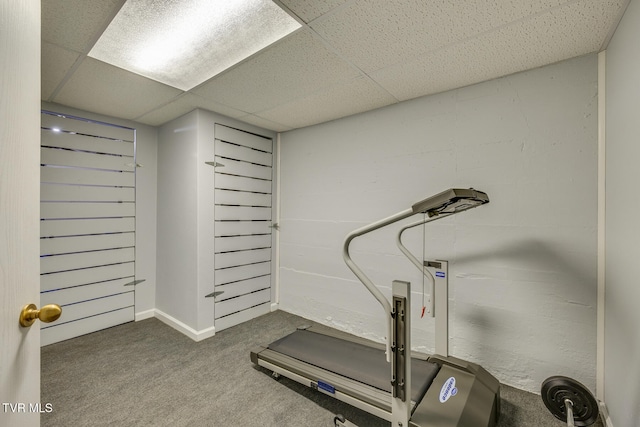 exercise area with a drop ceiling and carpet