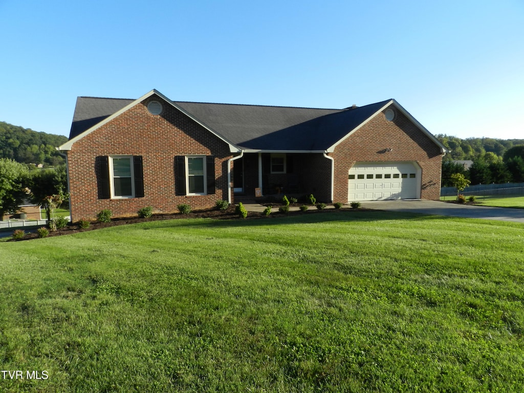 ranch-style home with a front yard and a garage