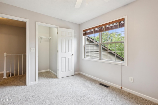 506 Pilgrim Ct Unit B, Johnson City, TN 37601 - unfurnished bedroom featuring a closet, a walk in closet, carpet, baseboards, and visible vents