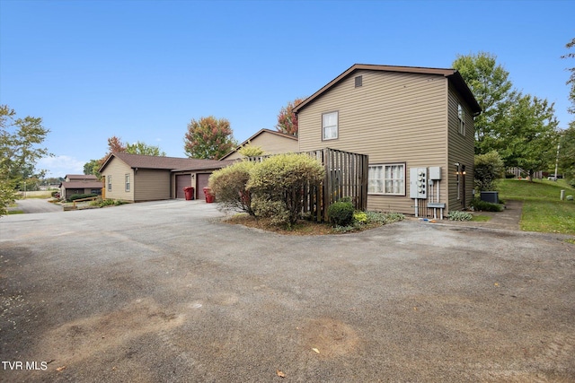 506 Pilgrim Ct Unit B, Johnson City, TN 37601 - view of side of property featuring aphalt driveway, central air condition unit, and a garage
