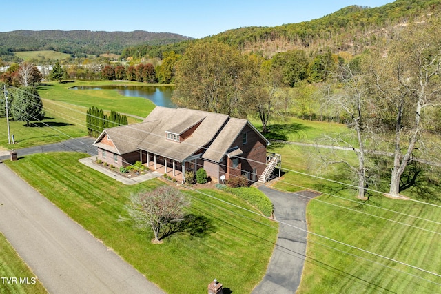 birds eye view of property with a water and mountain view