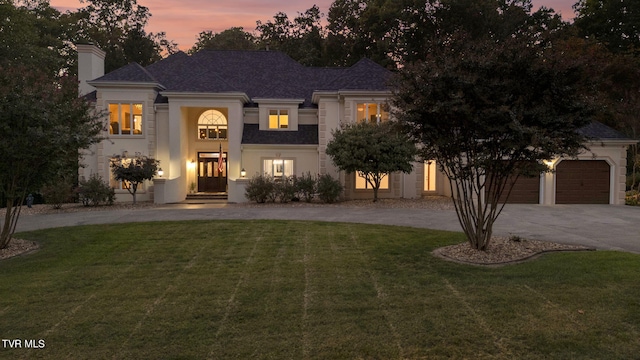 view of front facade with a lawn and a garage