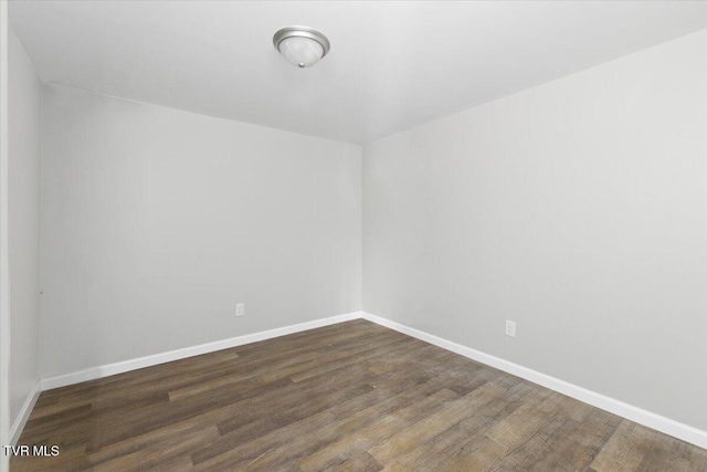 empty room with dark wood-type flooring