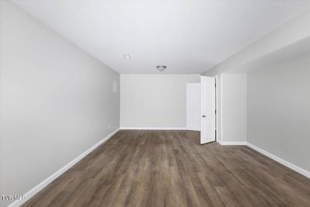 unfurnished room with dark hardwood / wood-style flooring