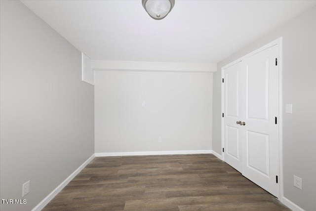 empty room with dark wood-type flooring