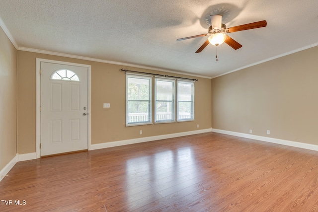 entryway with a textured ceiling, light hardwood / wood-style flooring, and plenty of natural light