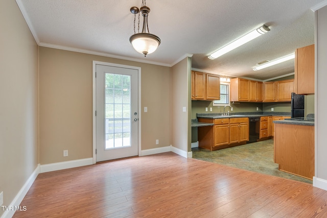 kitchen with hanging light fixtures, light hardwood / wood-style flooring, ornamental molding, and a textured ceiling