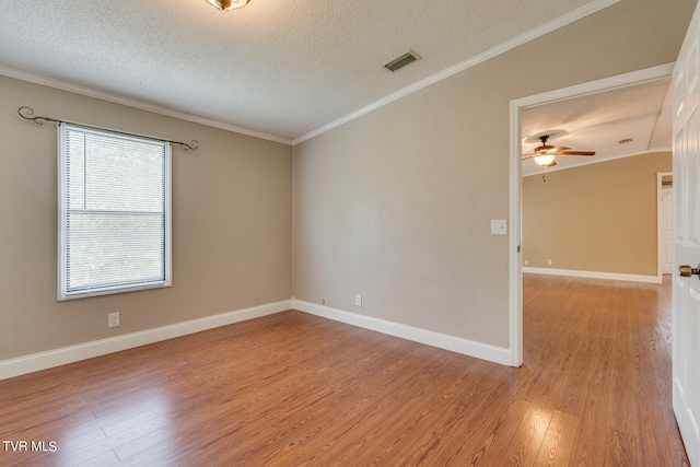 unfurnished room with a textured ceiling, ceiling fan, ornamental molding, and light hardwood / wood-style flooring