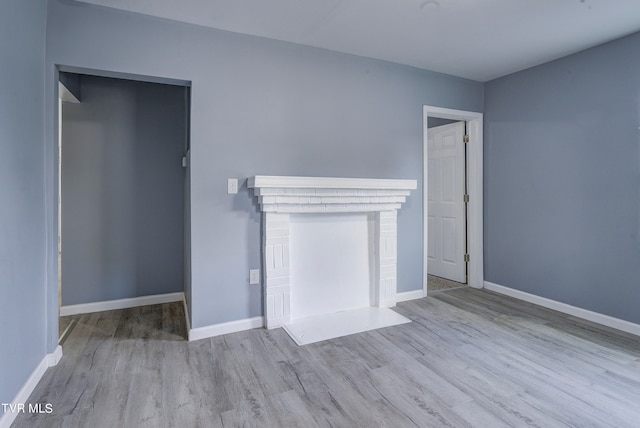 unfurnished living room featuring light wood-type flooring