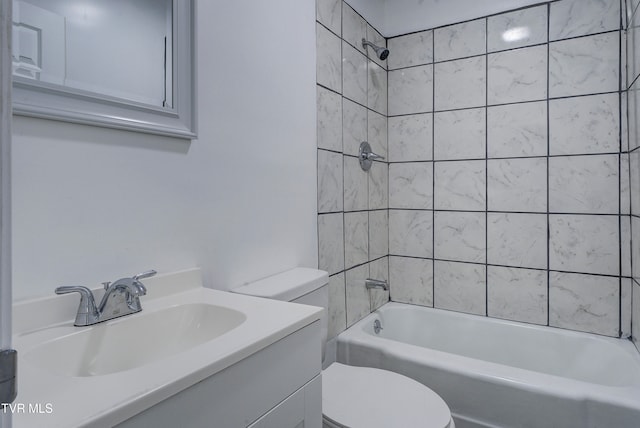 full bathroom featuring vanity, toilet, and tiled shower / bath combo