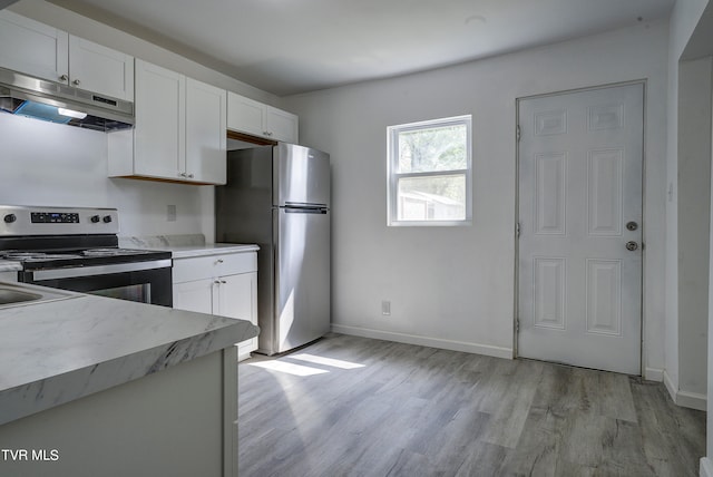 kitchen with appliances with stainless steel finishes, light wood-type flooring, and white cabinetry