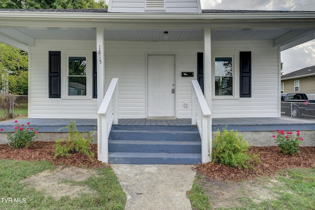 view of exterior entry featuring a porch