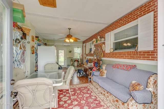 sunroom / solarium with an AC wall unit and ceiling fan