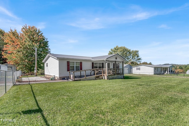 view of front of home featuring a wooden deck and a front lawn