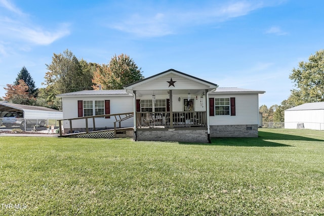 rear view of property featuring a yard and a porch