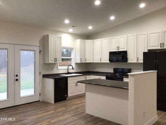 kitchen with a center island, sink, french doors, white cabinets, and black appliances