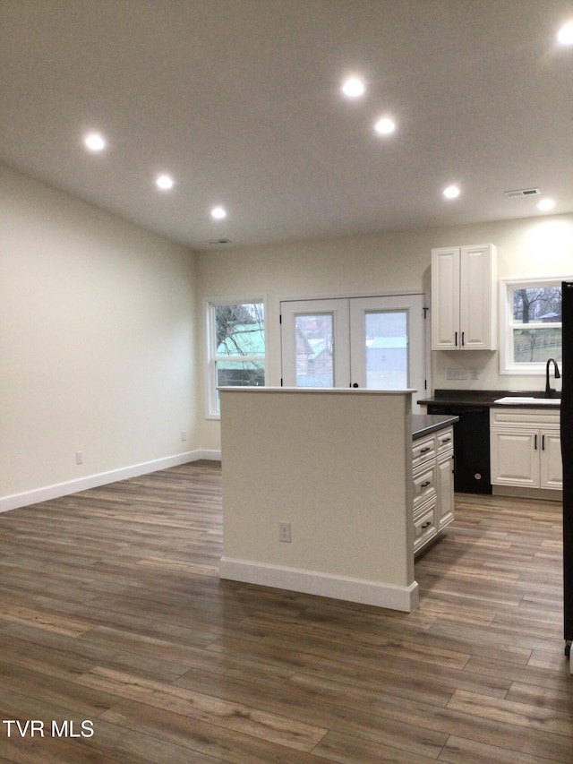 kitchen featuring dark hardwood / wood-style floors, white cabinetry, and sink