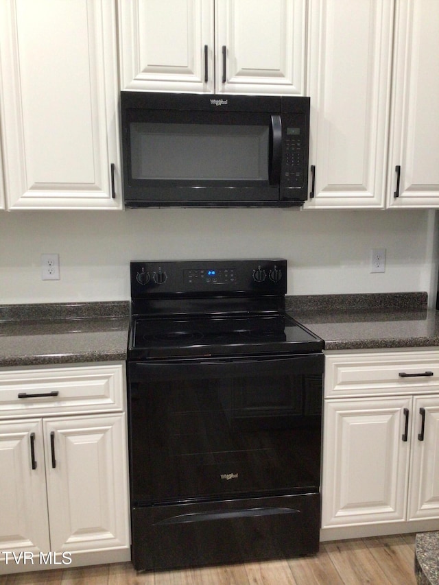 kitchen with white cabinetry, black appliances, and light wood-type flooring