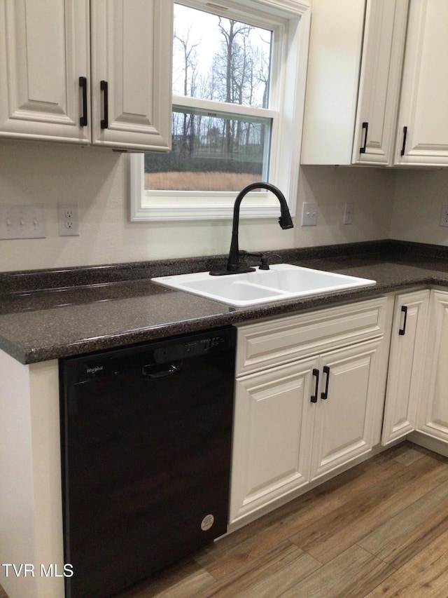 kitchen featuring dishwasher, white cabinets, dark hardwood / wood-style floors, and sink