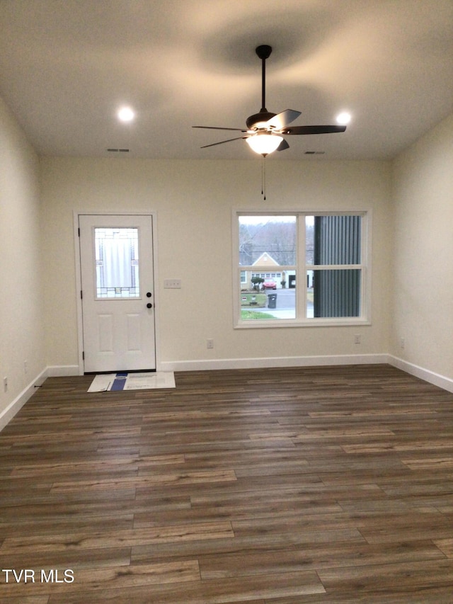 foyer with ceiling fan and dark wood-type flooring