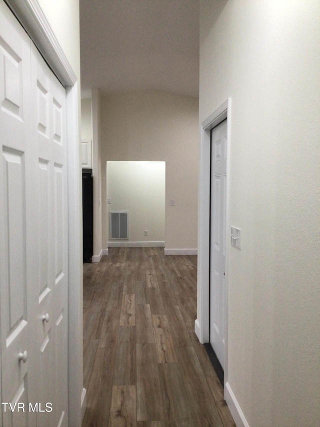 hallway with dark wood-type flooring