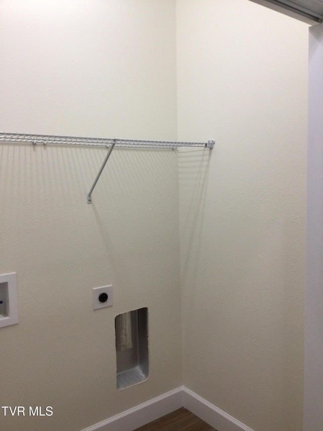 washroom featuring washer hookup, electric dryer hookup, and dark wood-type flooring