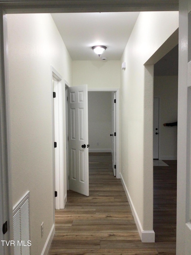 hallway with dark hardwood / wood-style floors