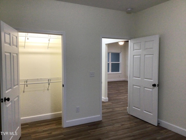 unfurnished bedroom featuring a closet and dark hardwood / wood-style floors