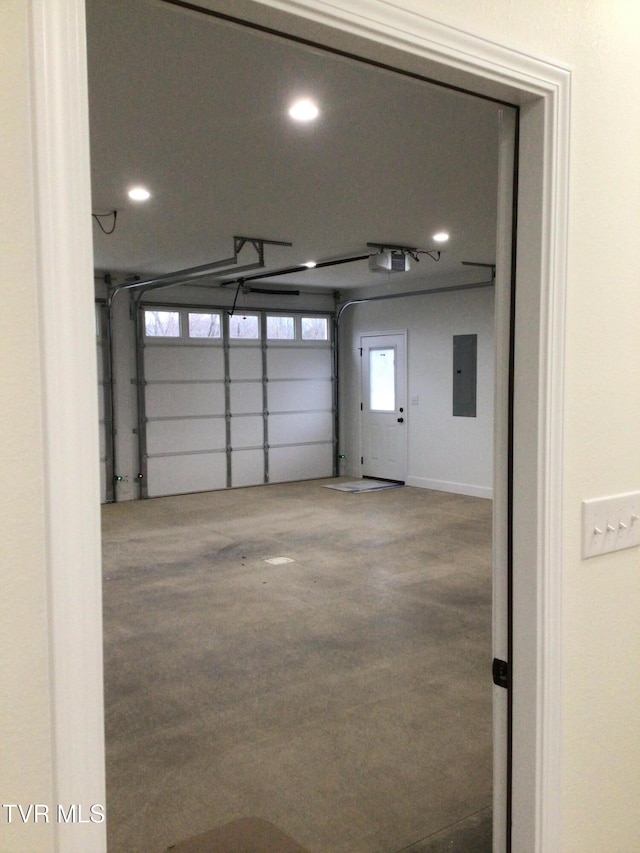 garage featuring electric panel and a garage door opener