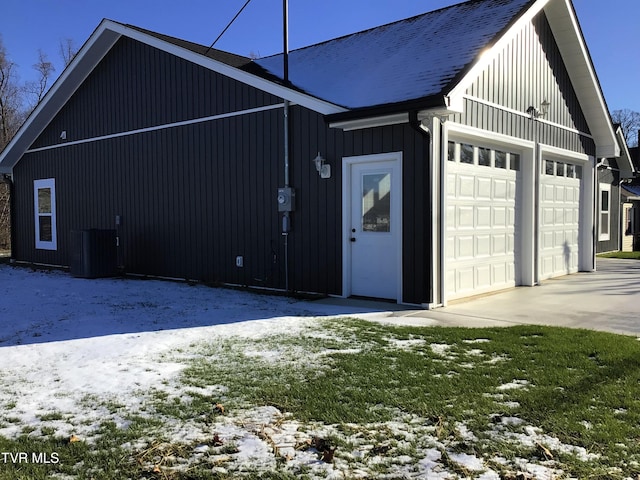 view of snow covered exterior with a garage