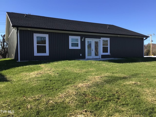 back of property featuring french doors and a yard