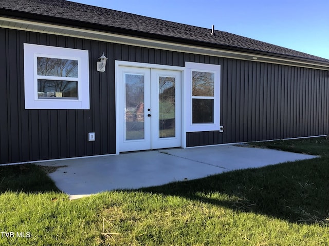 doorway to property with a lawn, a patio area, and french doors