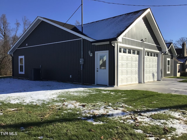 view of snowy exterior featuring a garage