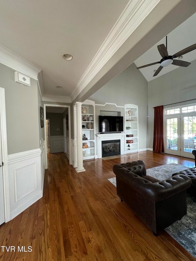 living room featuring ornate columns, dark hardwood / wood-style floors, ornamental molding, vaulted ceiling, and ceiling fan