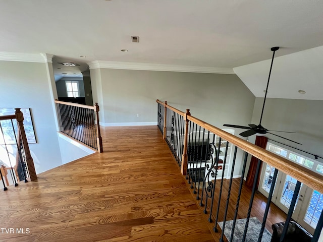 hall with lofted ceiling, ornamental molding, and hardwood / wood-style flooring