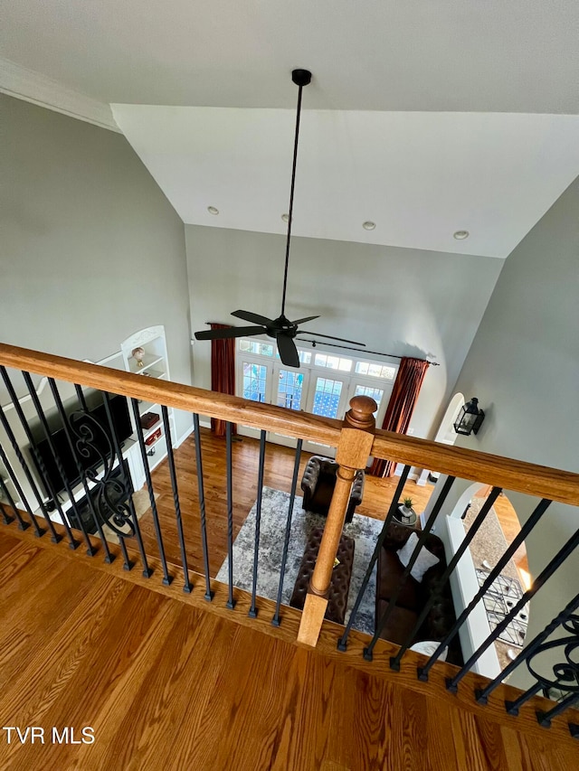 stairs with vaulted ceiling, wood-type flooring, and ceiling fan