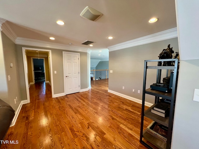 interior space featuring crown molding and hardwood / wood-style flooring