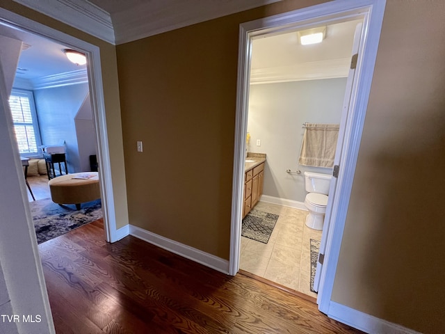 bathroom featuring vanity, ornamental molding, toilet, and wood-type flooring