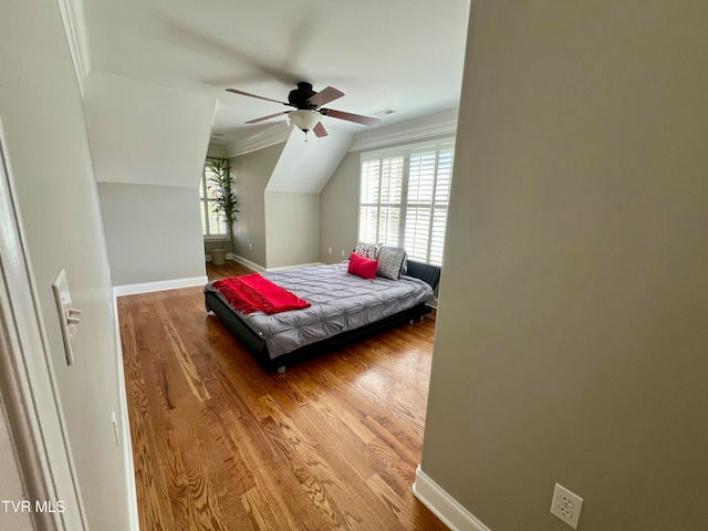 bedroom with ornamental molding, wood-type flooring, and ceiling fan