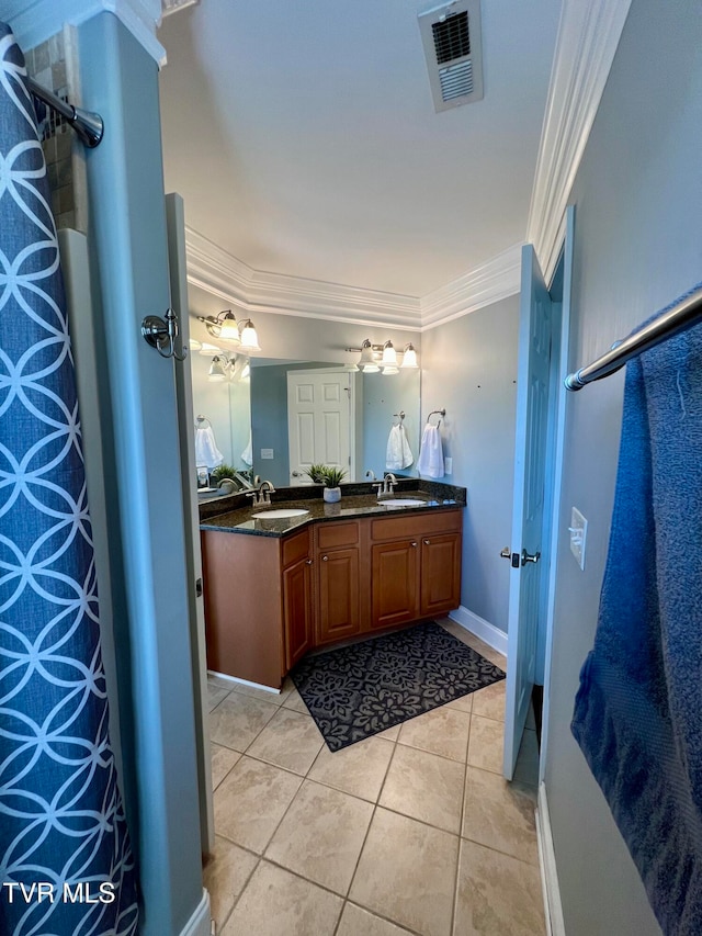 bathroom featuring vanity, crown molding, and tile patterned floors