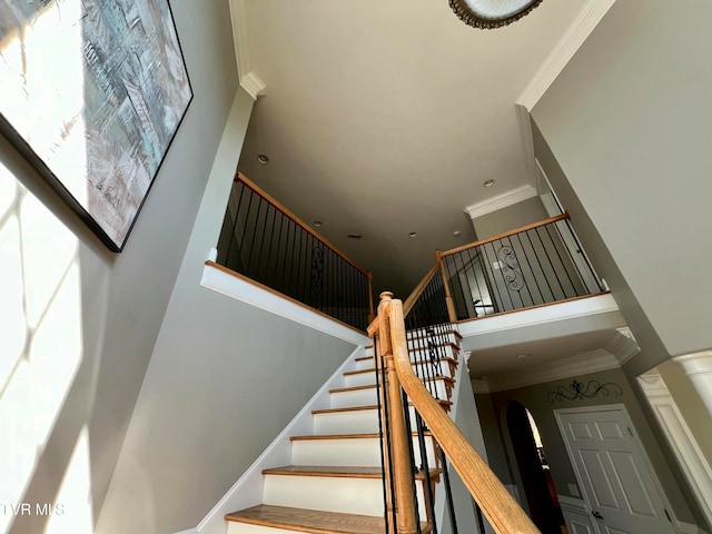 stairway featuring crown molding