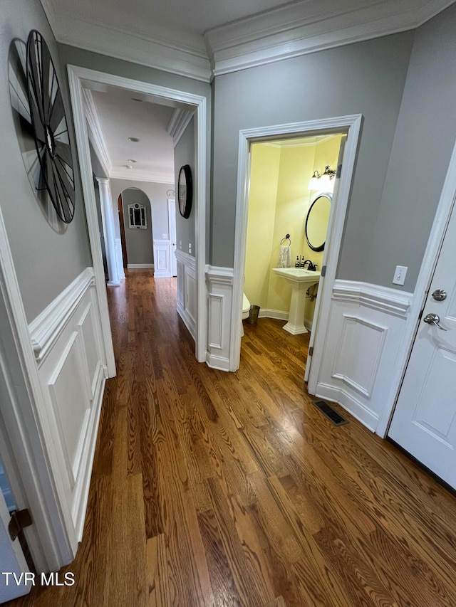 hall with crown molding and dark hardwood / wood-style flooring