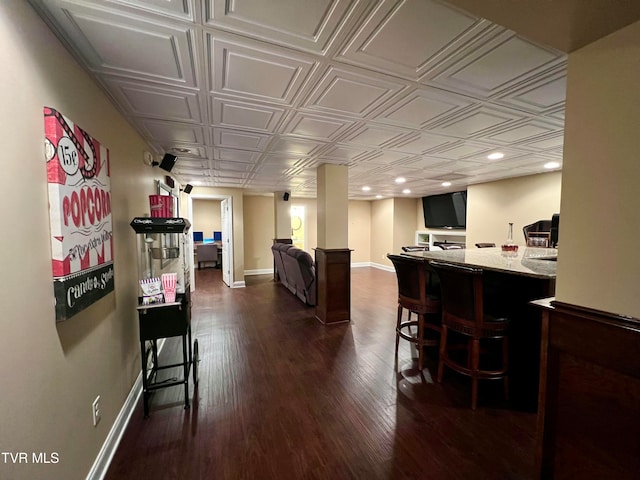 dining area with indoor bar and dark hardwood / wood-style flooring