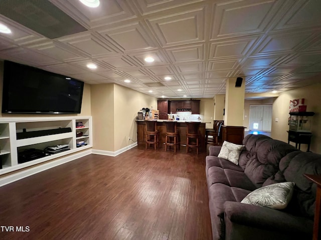 living room featuring built in features and dark hardwood / wood-style floors