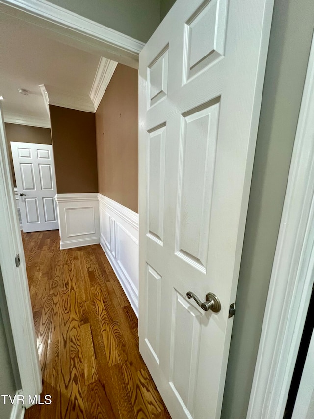 hall with crown molding and wood-type flooring