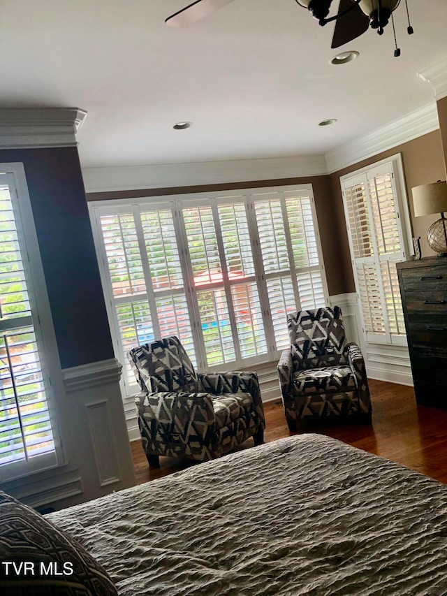 bedroom featuring dark wood-type flooring, crown molding, and ceiling fan