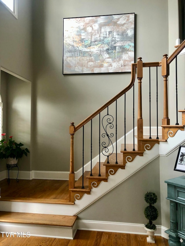 stairs featuring hardwood / wood-style flooring