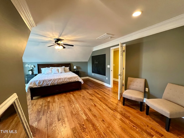 bedroom featuring ceiling fan, wood-type flooring, lofted ceiling, and ornamental molding